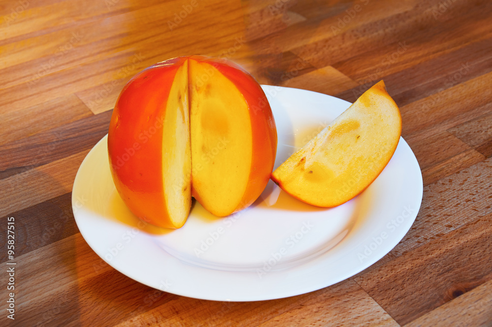 Asian juicy orange persimmon closeup Asian juicy orange persimmon closeup