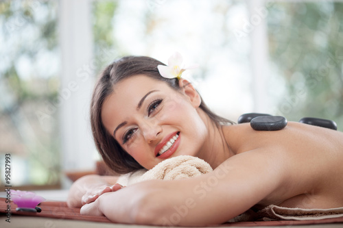 young beautiful woman relaxing in spa center