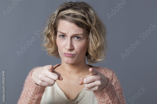 Canvastavla accusation and worry concept - upset 20s woman with blond curly hair looking con