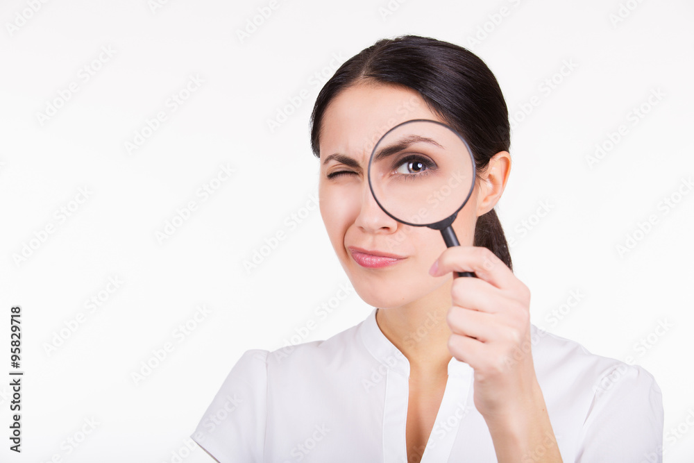 Beautiful girl searching with magnifier. White background Beautiful girl searching with magnifier. White background