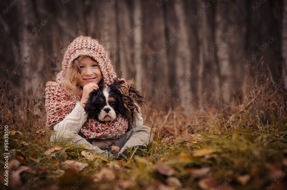happy friends child with her dog on cozy warm autumn walk