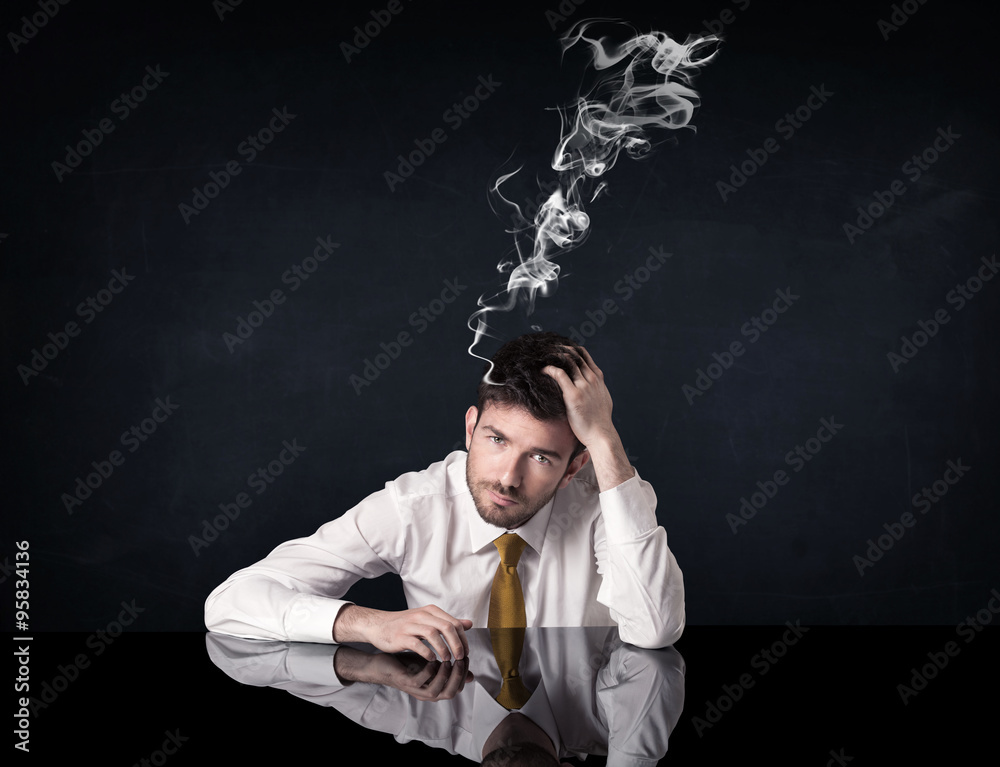 Depressed businessman with smoking head