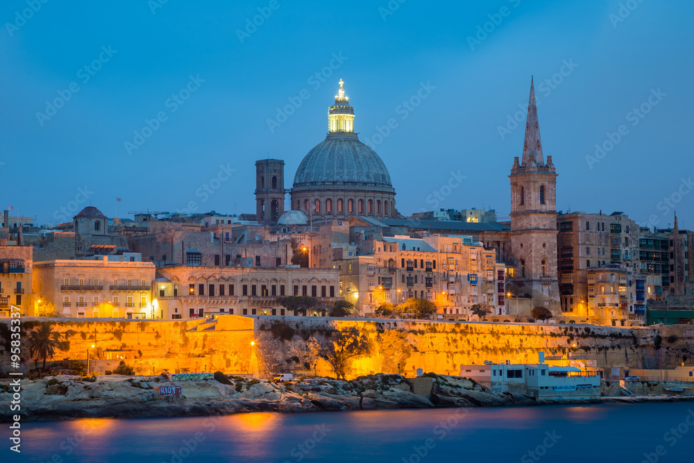Valletta seafront skyline view as seen from Sliema, Malta.St Paul's Cathedral after sunset.