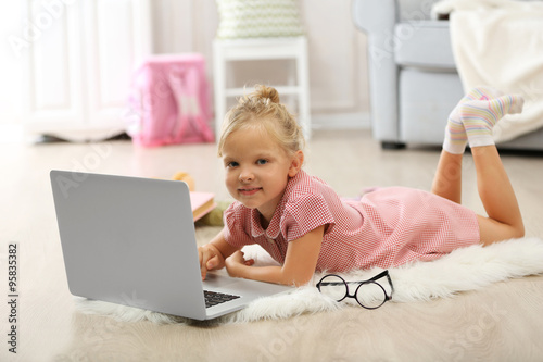 Little girl with laptop in ...