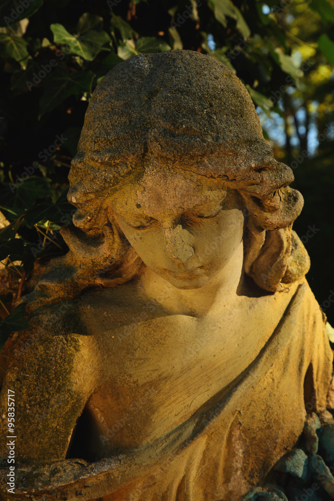 Fototapeta premium golden angel in the sunlight (antique statue)