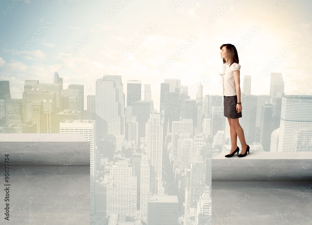 Businesswoman standing on the edge of rooftop Businesswoman standing on the edge of rooftop