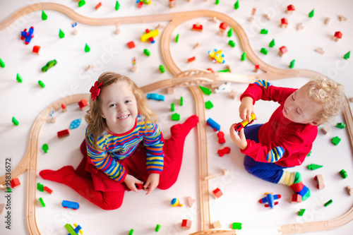 Kids playing with wooden train set