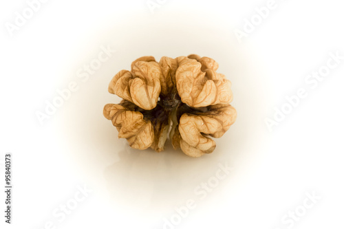 Walnut. Whole bright kernel of shelled walnuts on a white background.