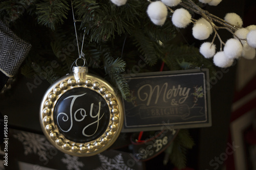 Christmas tree decoration ornaments for the holidays, close of an ornament with the word Joy
