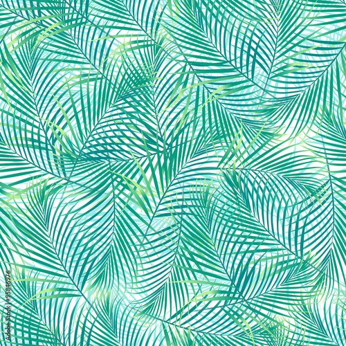 Tropical palm leaves in a seamless pattern on a white background