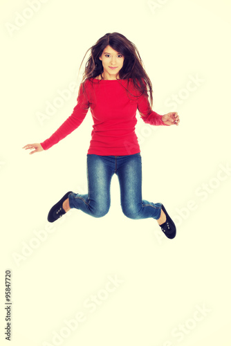 Fototapeta Naklejka Na Ścianę i Meble -  Young woman student jumping. 