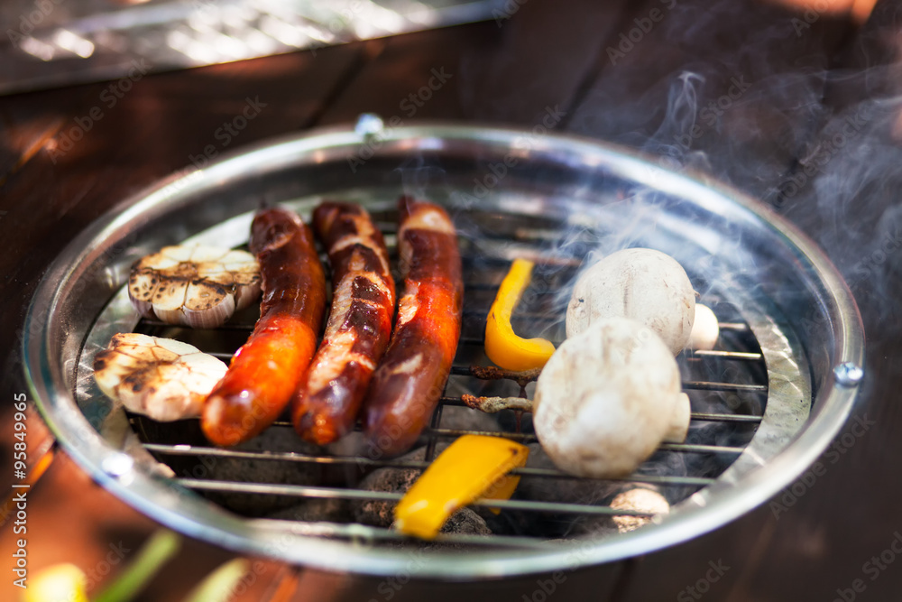 sausages and mushrooms on the grill sausages and mushrooms on the grill