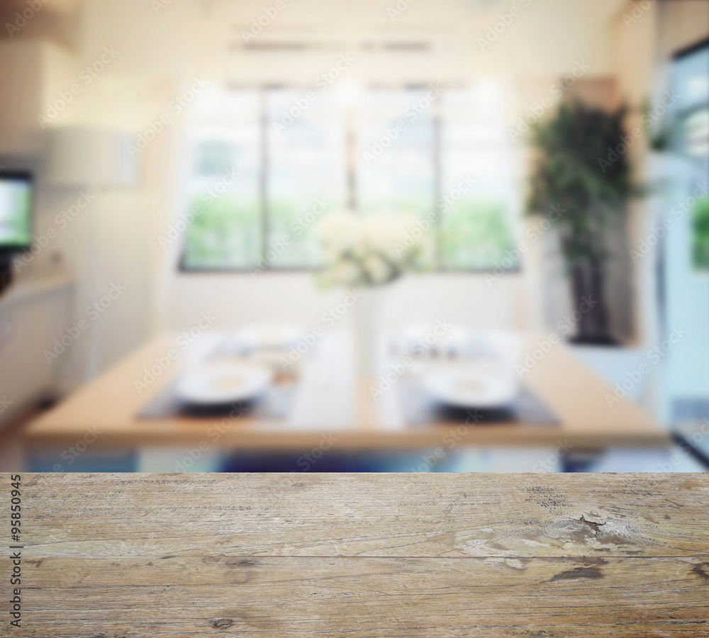 wooden table top with blur of modern dining room interior. wooden table top with blur of modern dining room interior.