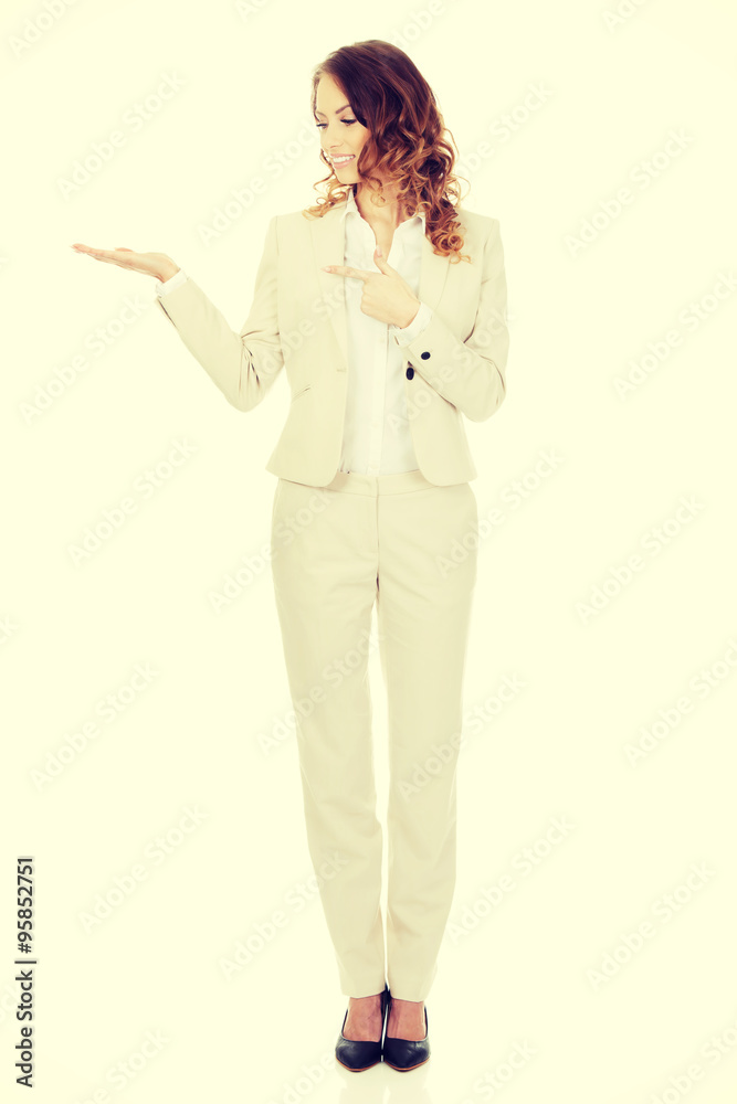 Woman pointing on her palm. Woman pointing on her palm.
