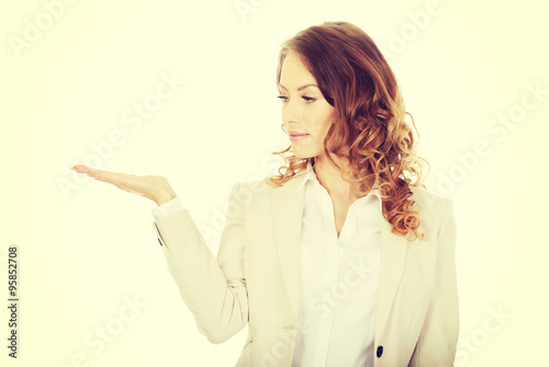 Woman showing something on palm.