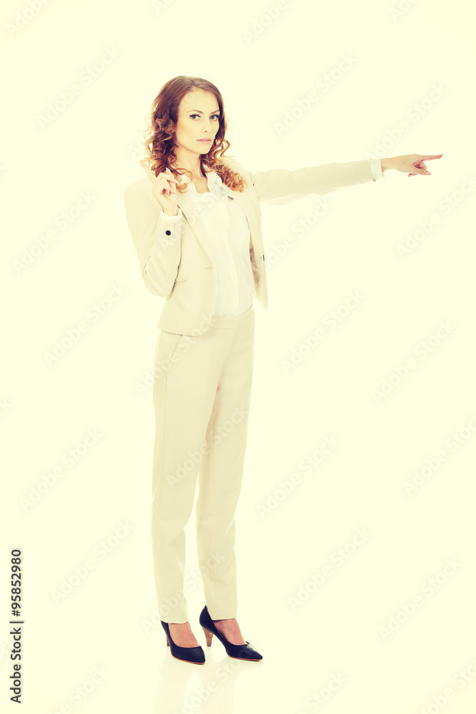 Attractive businesswoman pointing her finger. Attractive businesswoman pointing her finger.