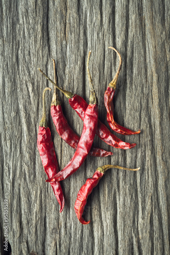 Dried Red Hot Chili Peppers on rustic wooden background, Overhea