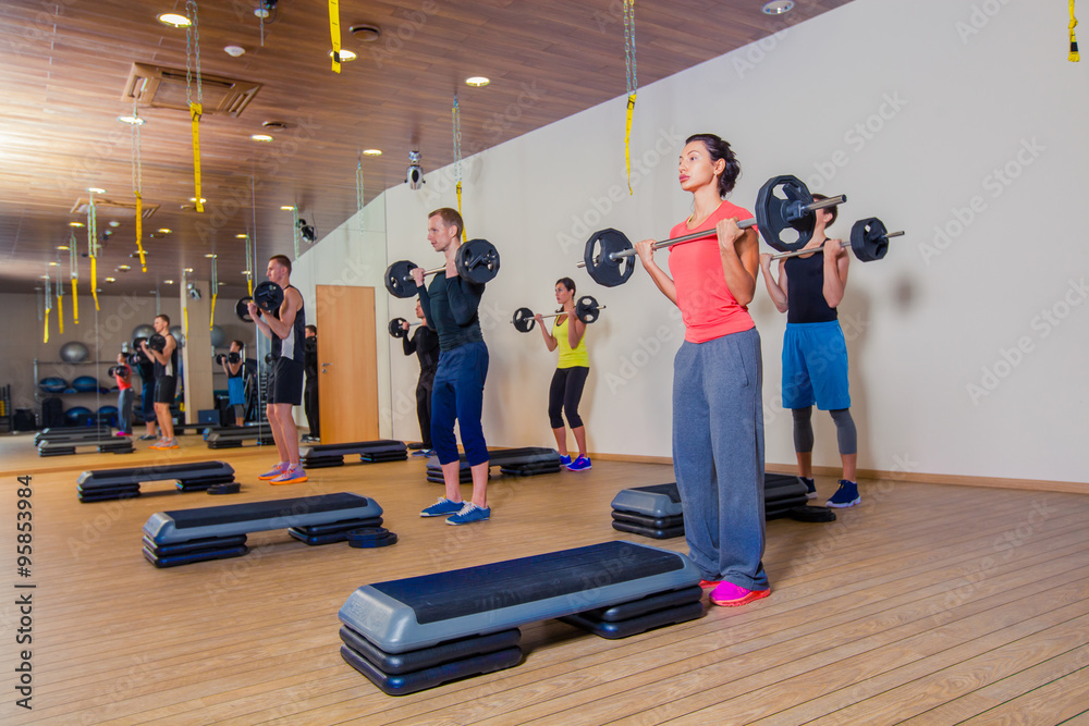 Obraz premium Sport, fitness, lifestyle and people concept - group flexing muscles with barbells in gym