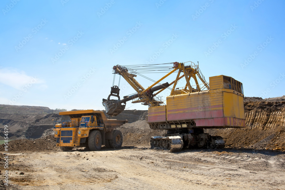 Coal mining. The dredge loads the truck ground. Coal mining. The dredge loads the truck ground.
