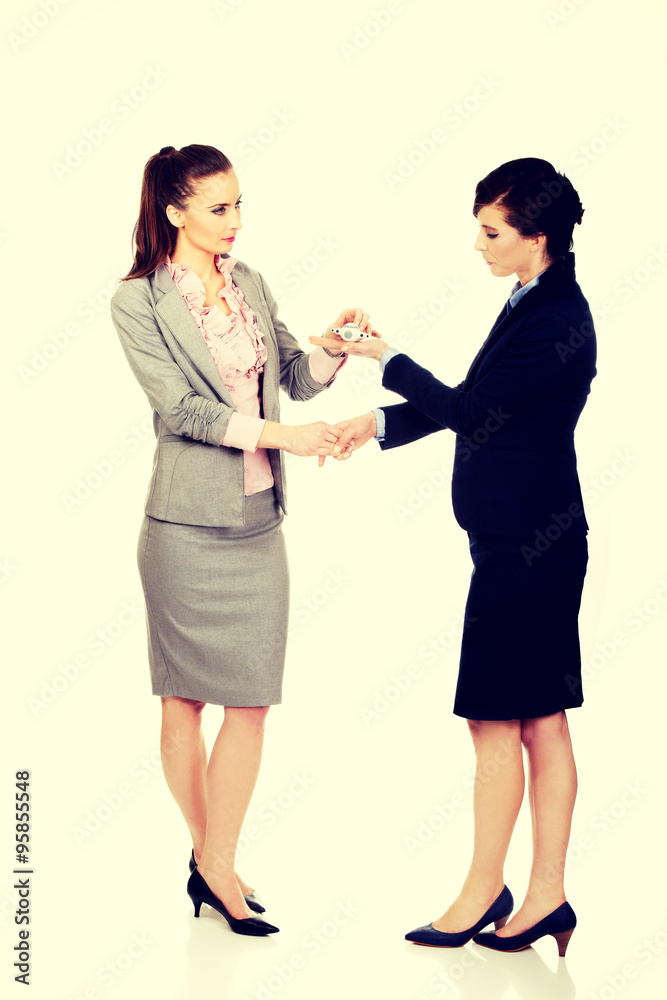 Businesswoman giving a plane to her partner.