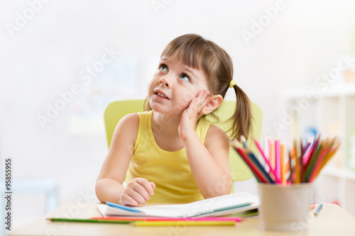thoughful child girl drawin...