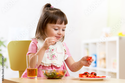 child eats healthy food in kindergarten or at home