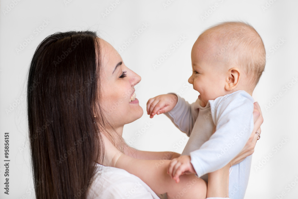 Portrait of mother and baby laughing and playing Portrait of mother and baby laughing and playing