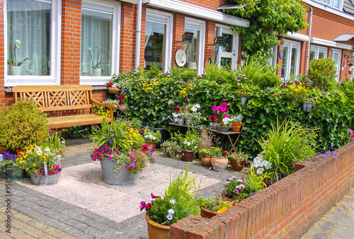 Street view of traditional house decorated with plants and furni