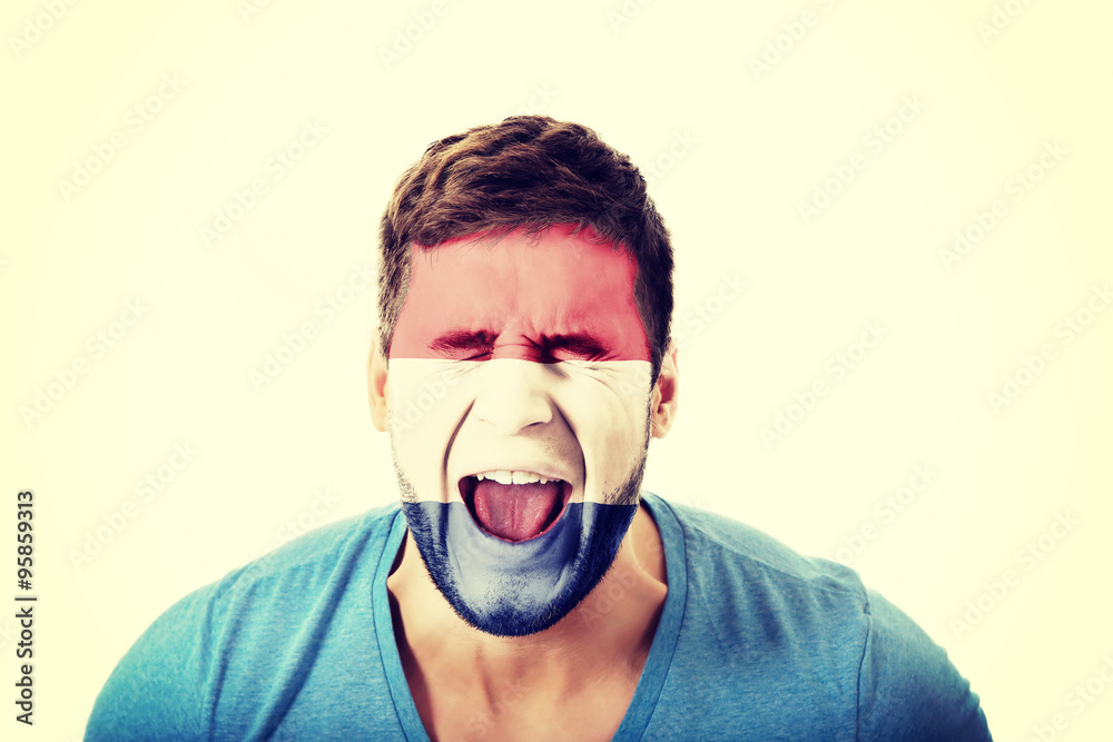 Screaming man with Netherlands flag on face. Screaming man with Netherlands flag on face.