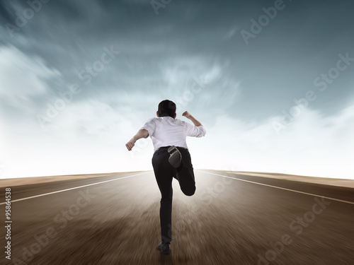 Back view of business man running photo