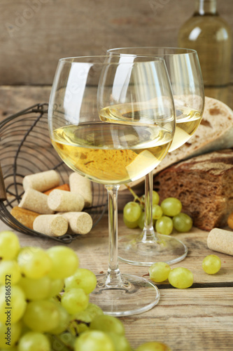 Still life of wine and bread on rustic wooden background