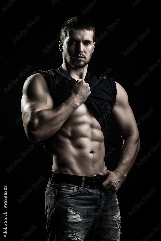 Fototapeta premium Muscular man with shirt on shoulder