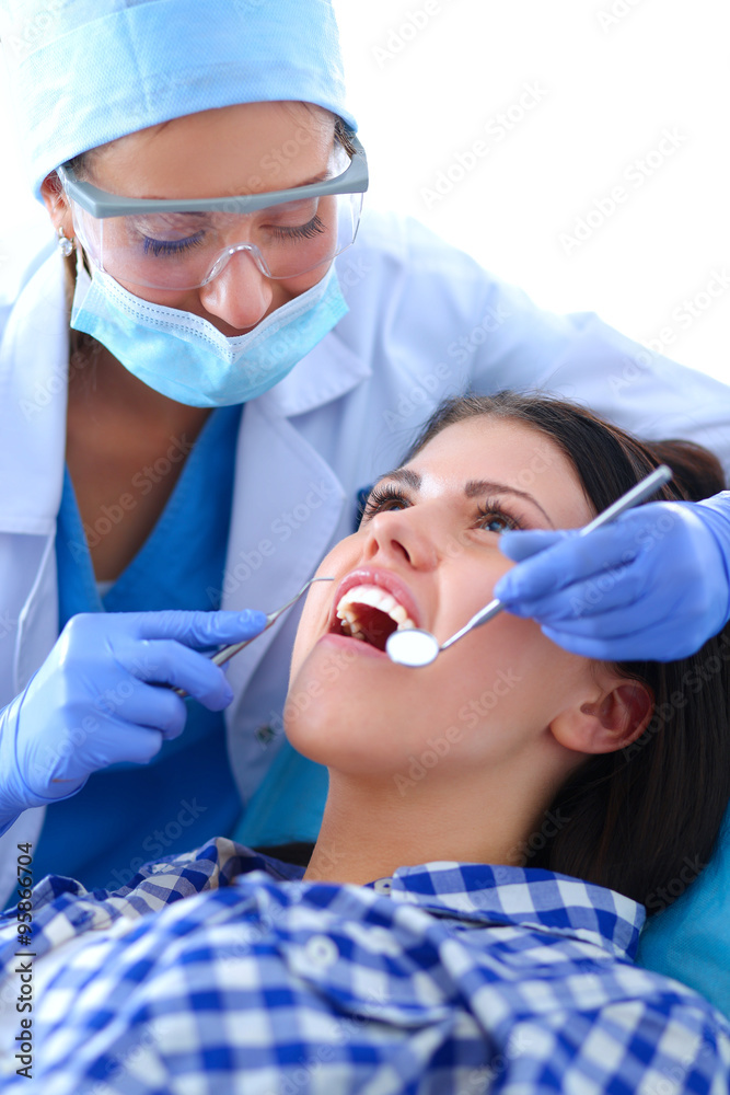 Woman dentist working at her patients teeth Woman dentist working at her patients teeth
