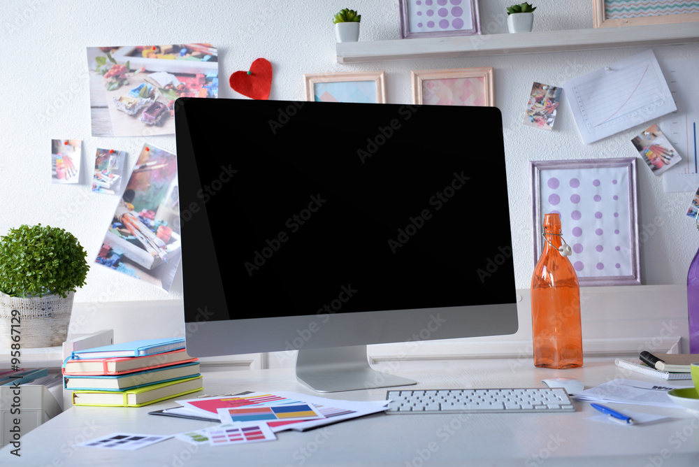 Fototapeta premium Modern workplace with computer on the table in decorated room