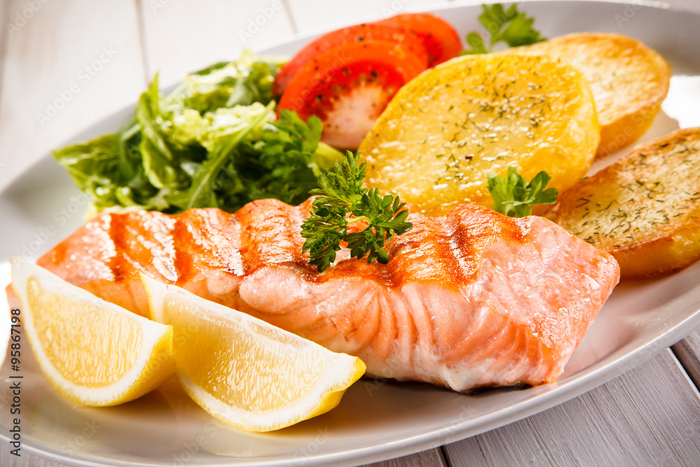 Fried salmon and vegetables on white background Fried salmon and vegetables on white background