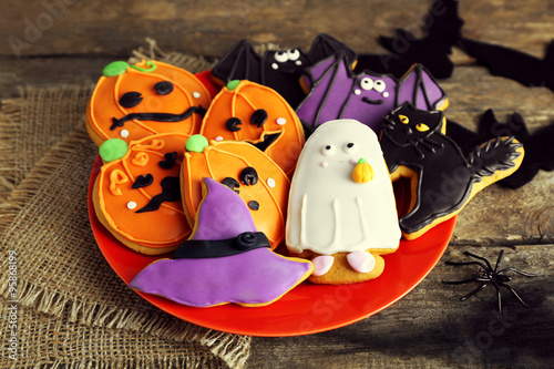 Creative Halloween cookies on wooden background