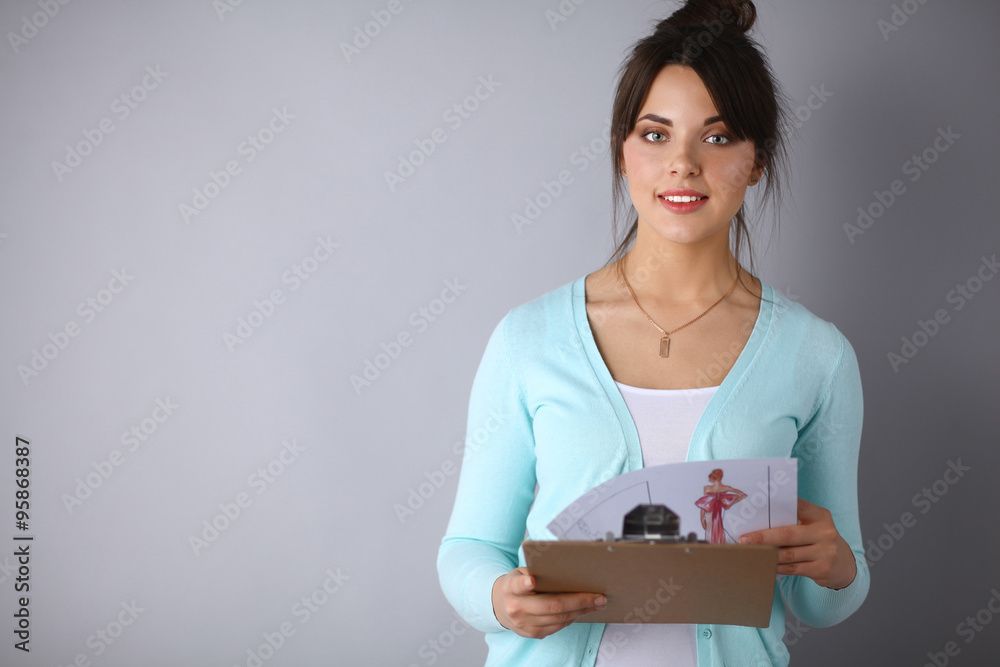 Woman with folder for documents on gray  background