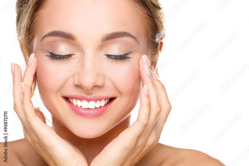 Young woman touching her face isolated on white background