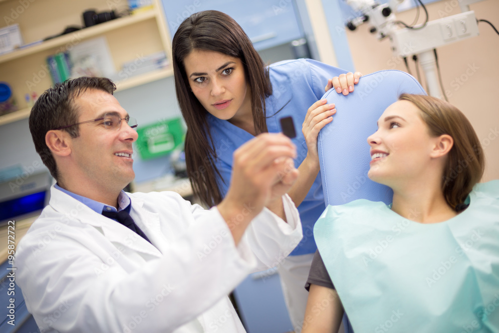 Dentist show film to his assistant in dental clinic Dentist show film to his assistant in dental clinic