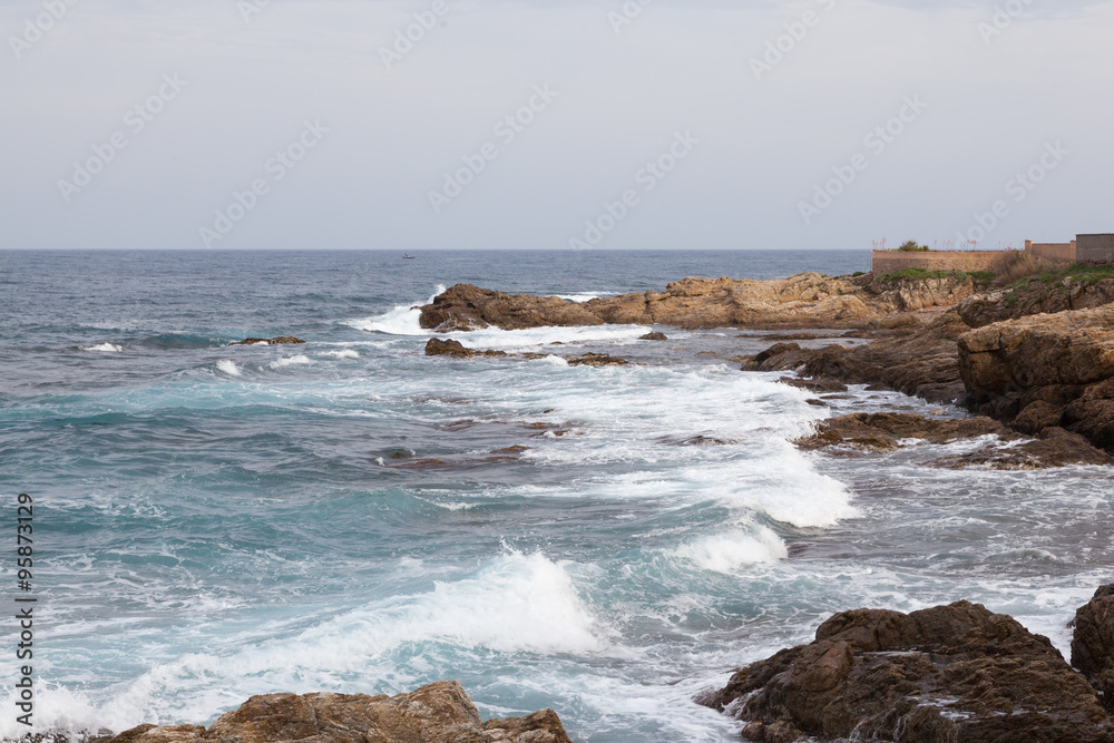 Sea waves running onto the rocky shore Sea waves running onto the rocky shore
