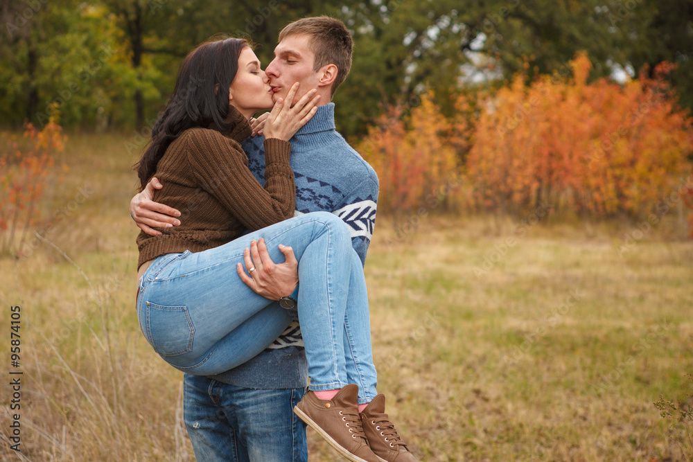 girl at the hands of Man. A loving couple walking in the autumn girl at the hands of Man. A loving couple walking in the autumn