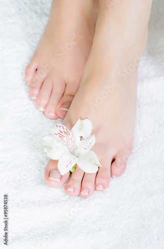 beautiful feet with pedicure and flowers