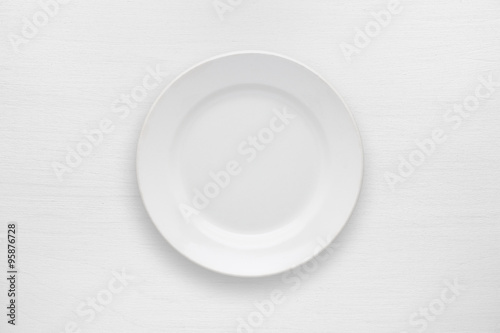 Empty plate on white table top view