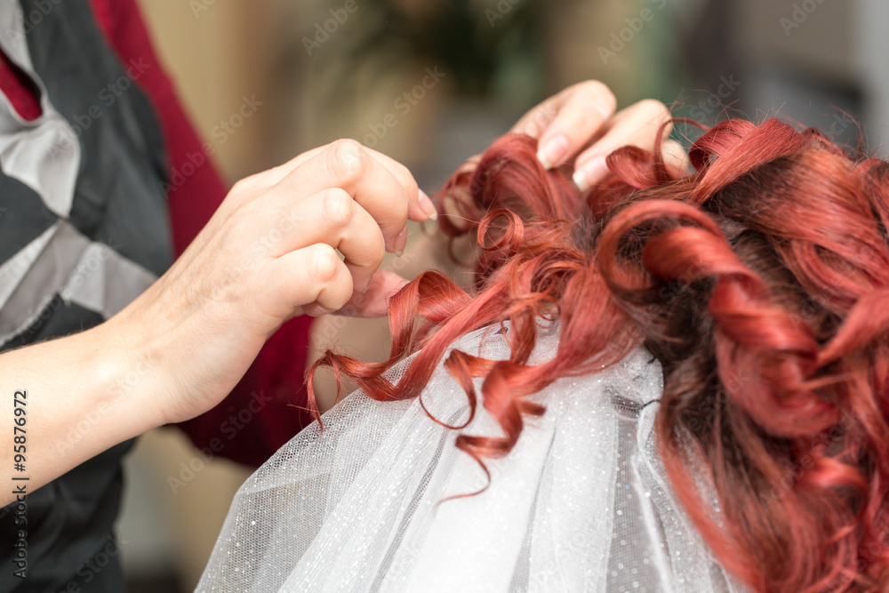 Fototapeta premium Wedding hairstyles with veil in the beauty salon