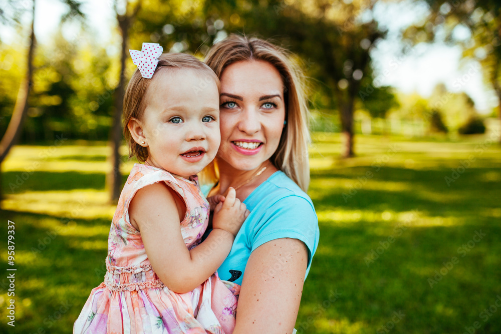 Happy mom and daughter smiling at nature. Happy mom and daughter smiling at nature.