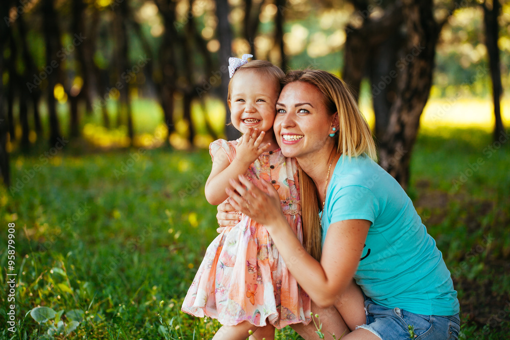 Fototapeta premium Happy mom and daughter smiling at nature.