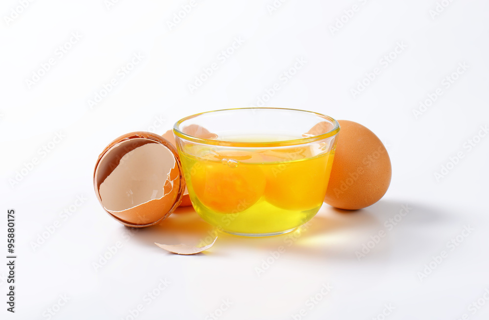 Egg whites and yolks in glass bowl Egg whites and yolks in glass bowl
