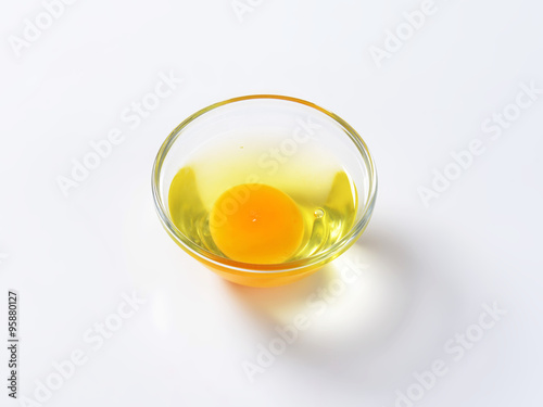 Egg white and yolk in glass bowl
