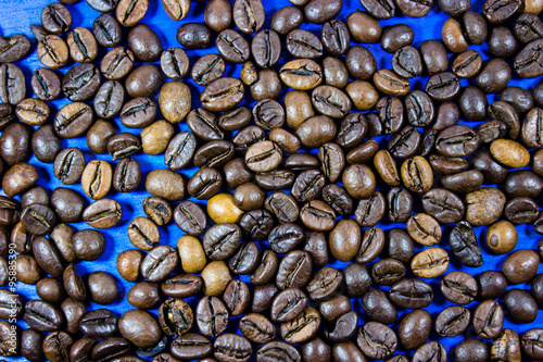Coffee beans isolated on blue wooden background photo