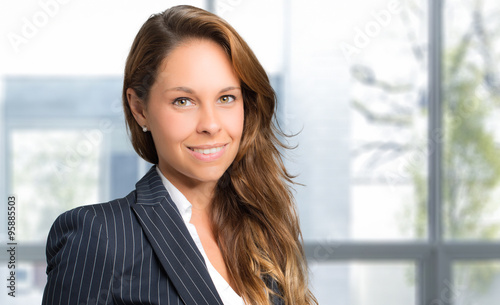 Young businesswoman portrait in her office © Minerva Studio